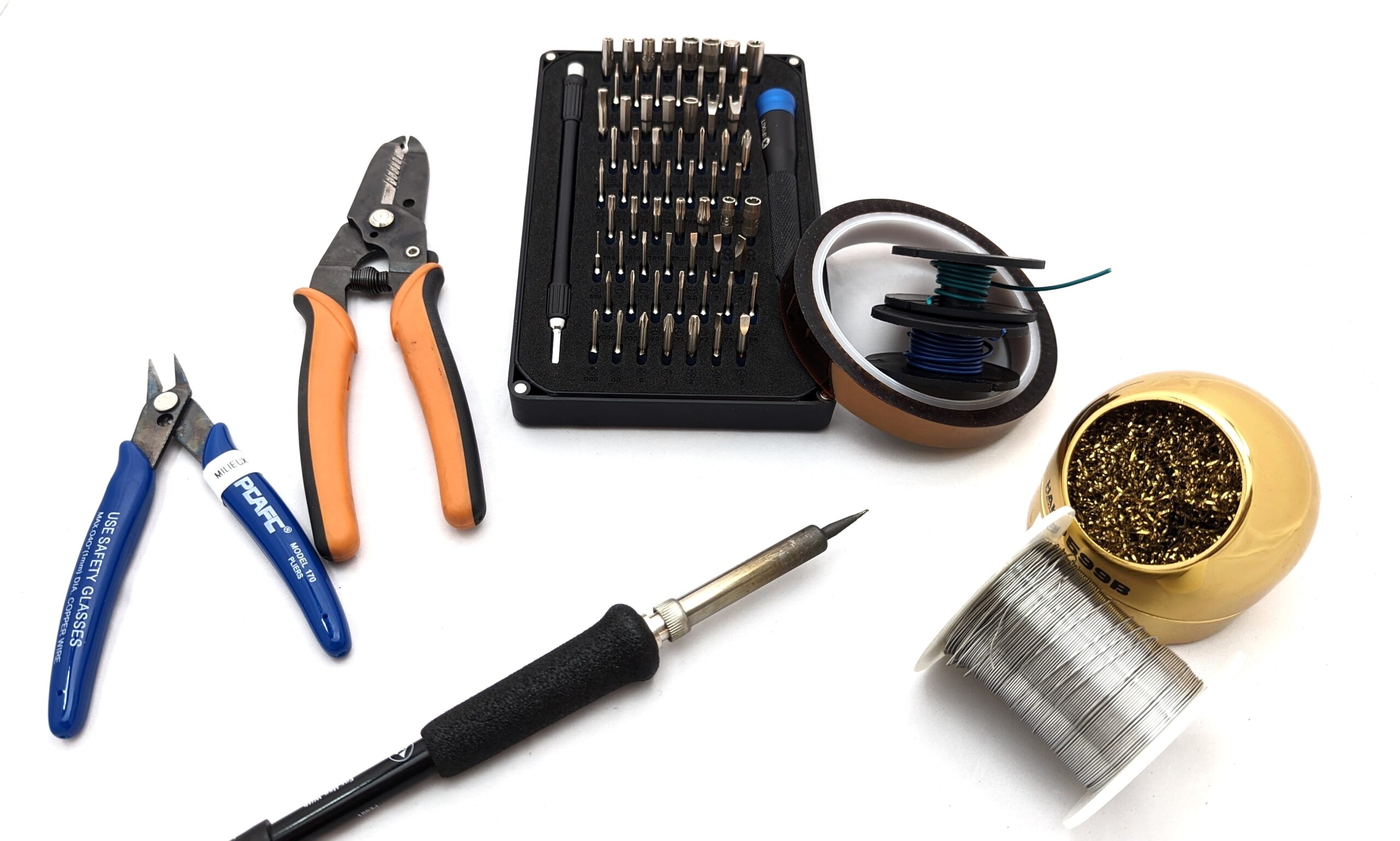 A collection of tools, including a soldering iron, wire strippers, solder, and a screwdriver kit.
