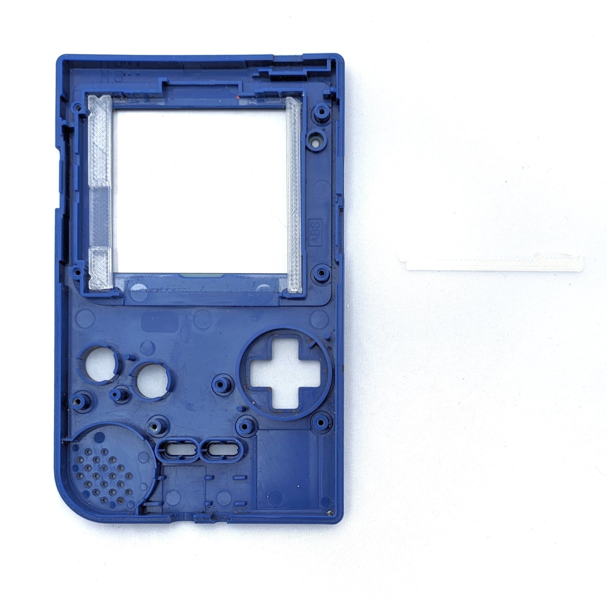 The inside of the front shell of the Game Boy, with bumpers dispalyed next to the screen.