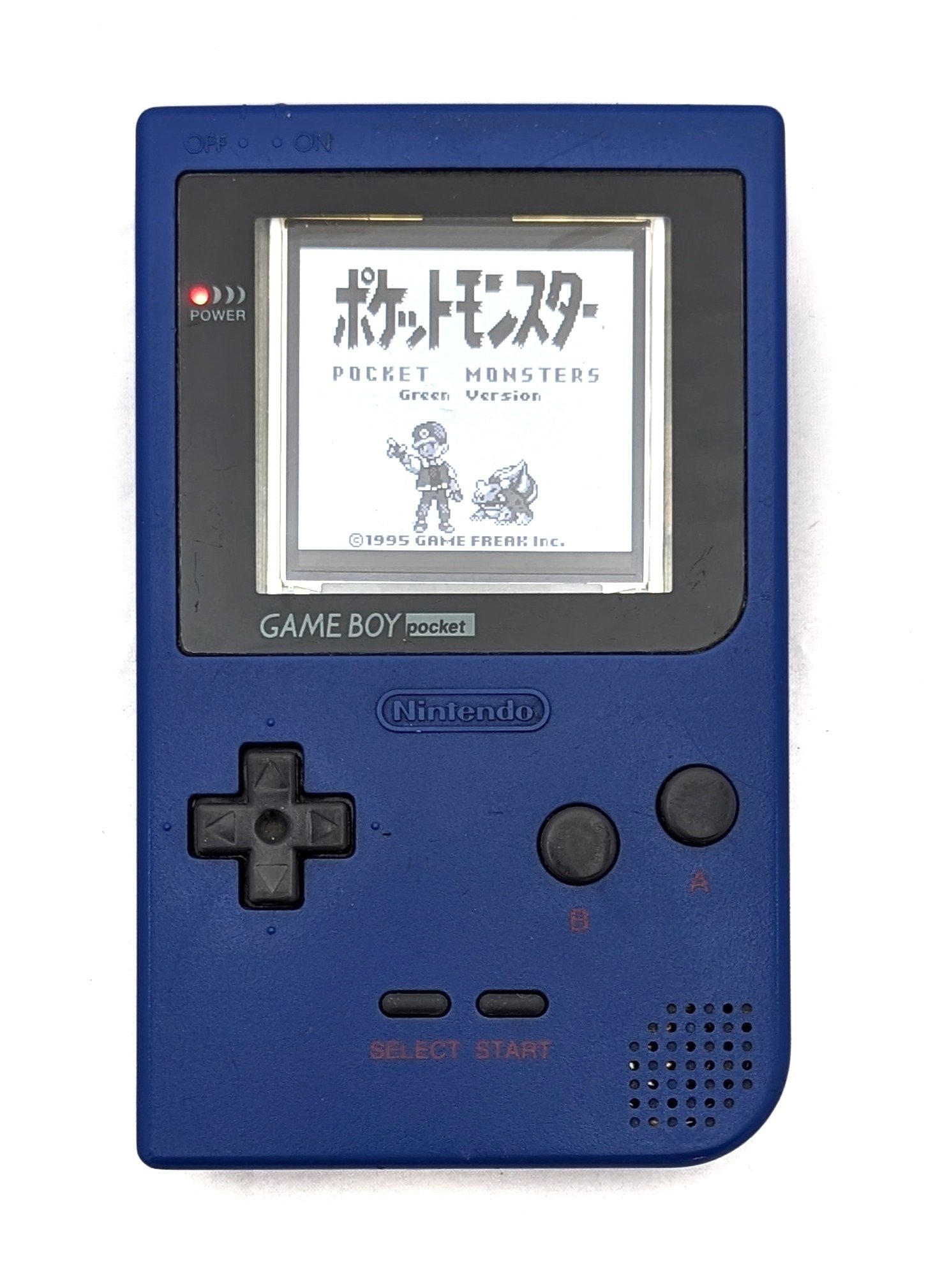 A powered-on game boy with Pokemon Green (japanese)