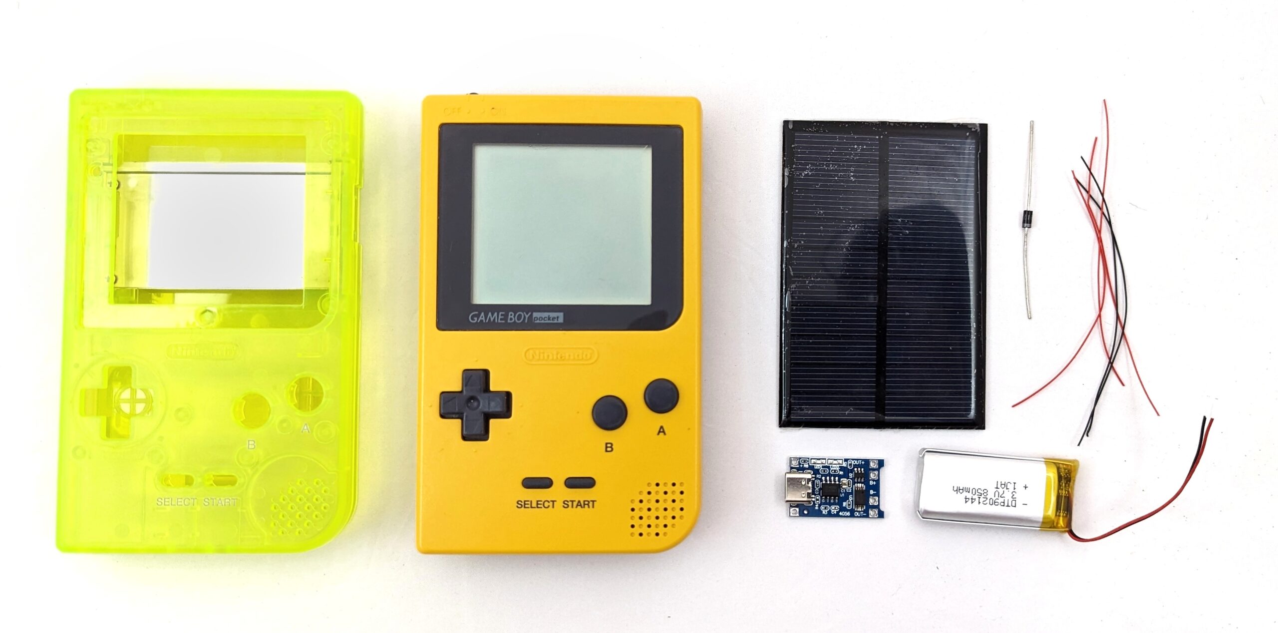 A view of components used in this modding tutorial: a green aftermarket game boy shell, a game boy pocket, a solar panel, a diode, some wire, a charge controller, and a battery.