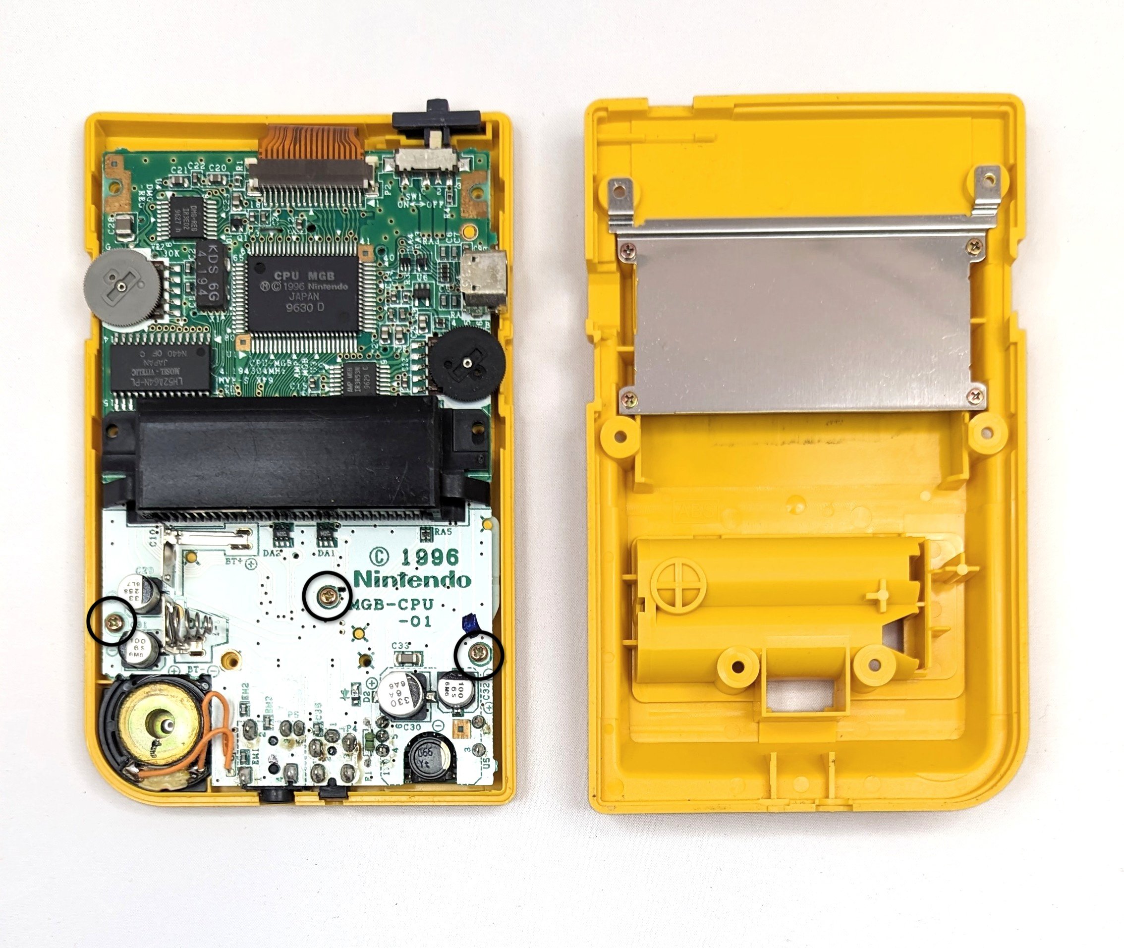 an open game boy pocket witht he pcb exposed and diagrams drawn over the removable screws
